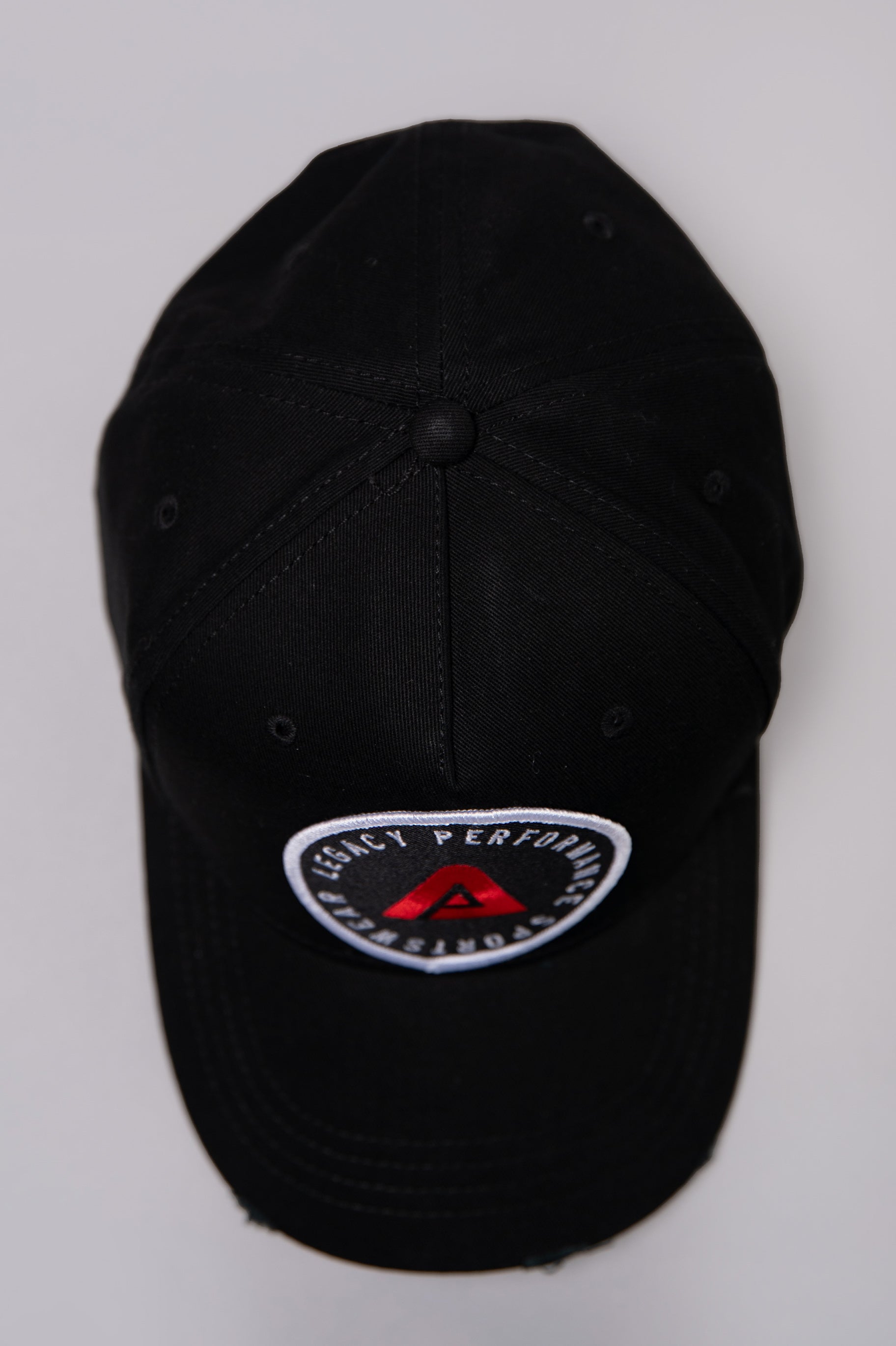Black Legacy baseball cap with white and red logo.