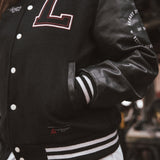 Black letterman jacket with wool body and leather sleeves.