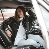 Black letterman jacket with wool body and leather sleeves.