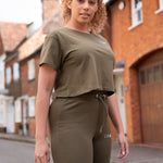Women's olive crop t-shirt with small white logo.