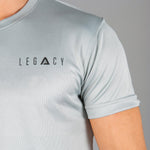 Close up of black logo on men's silver moisture wicking crewneck t-shirt.