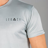 Close up of black logo on men's silver moisture wicking crewneck t-shirt.