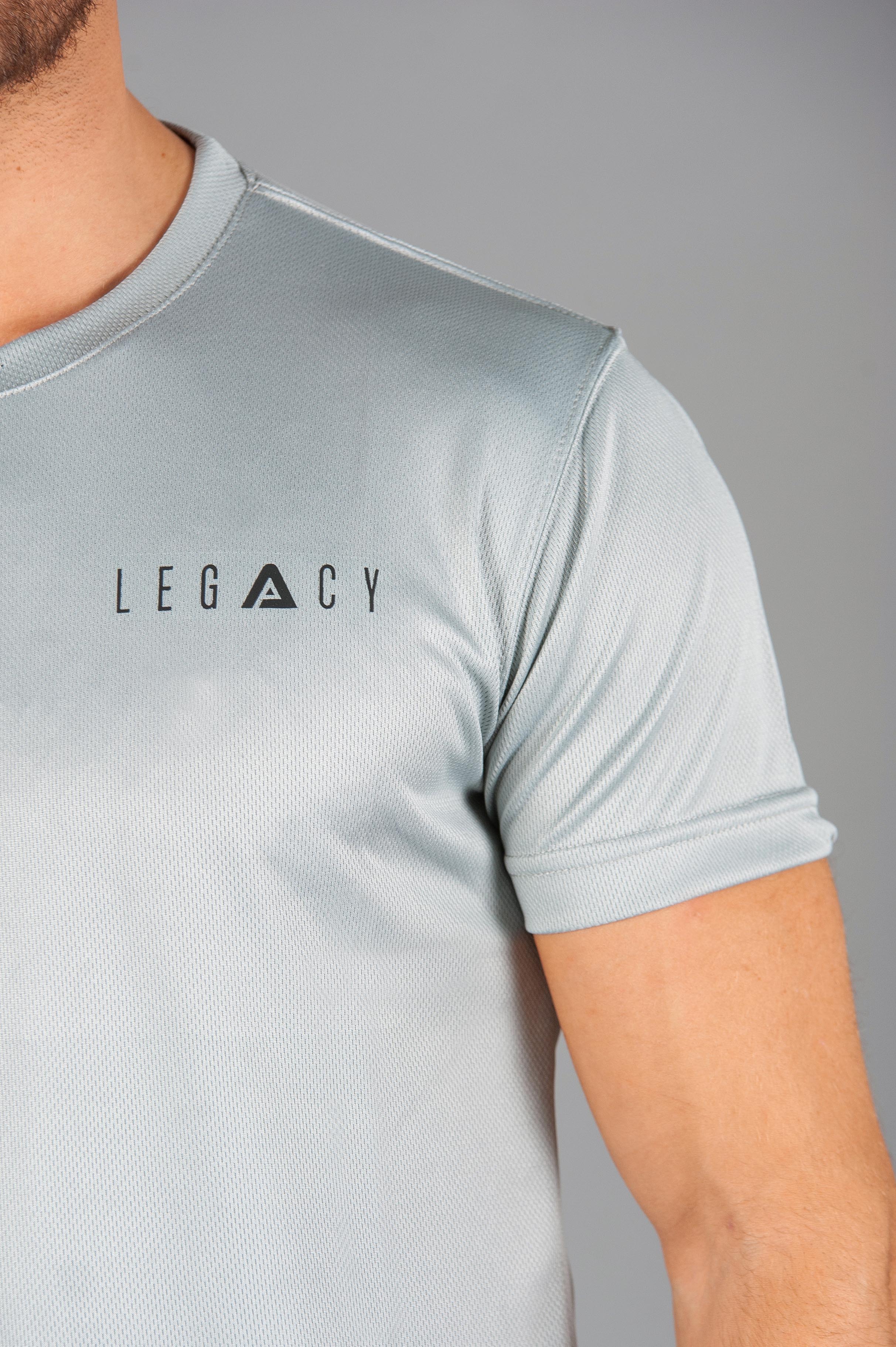 Close up of black logo on men's silver moisture wicking crewneck t-shirt.