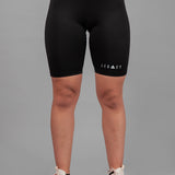 Women's black bike shorts with small white Legacy logo on the leg.