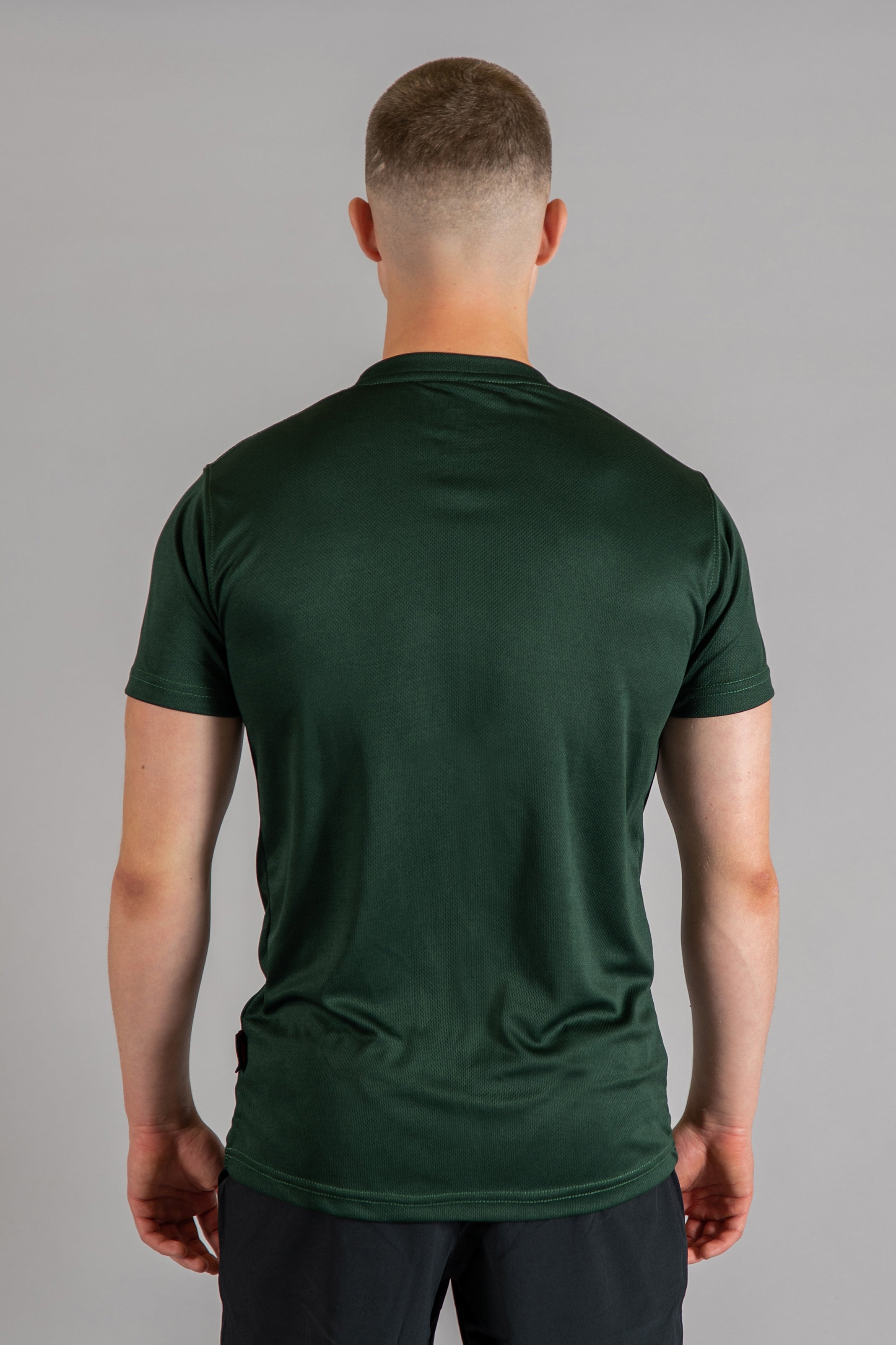 Back view of men's forest green moisture wicking crewneck t-shirt.