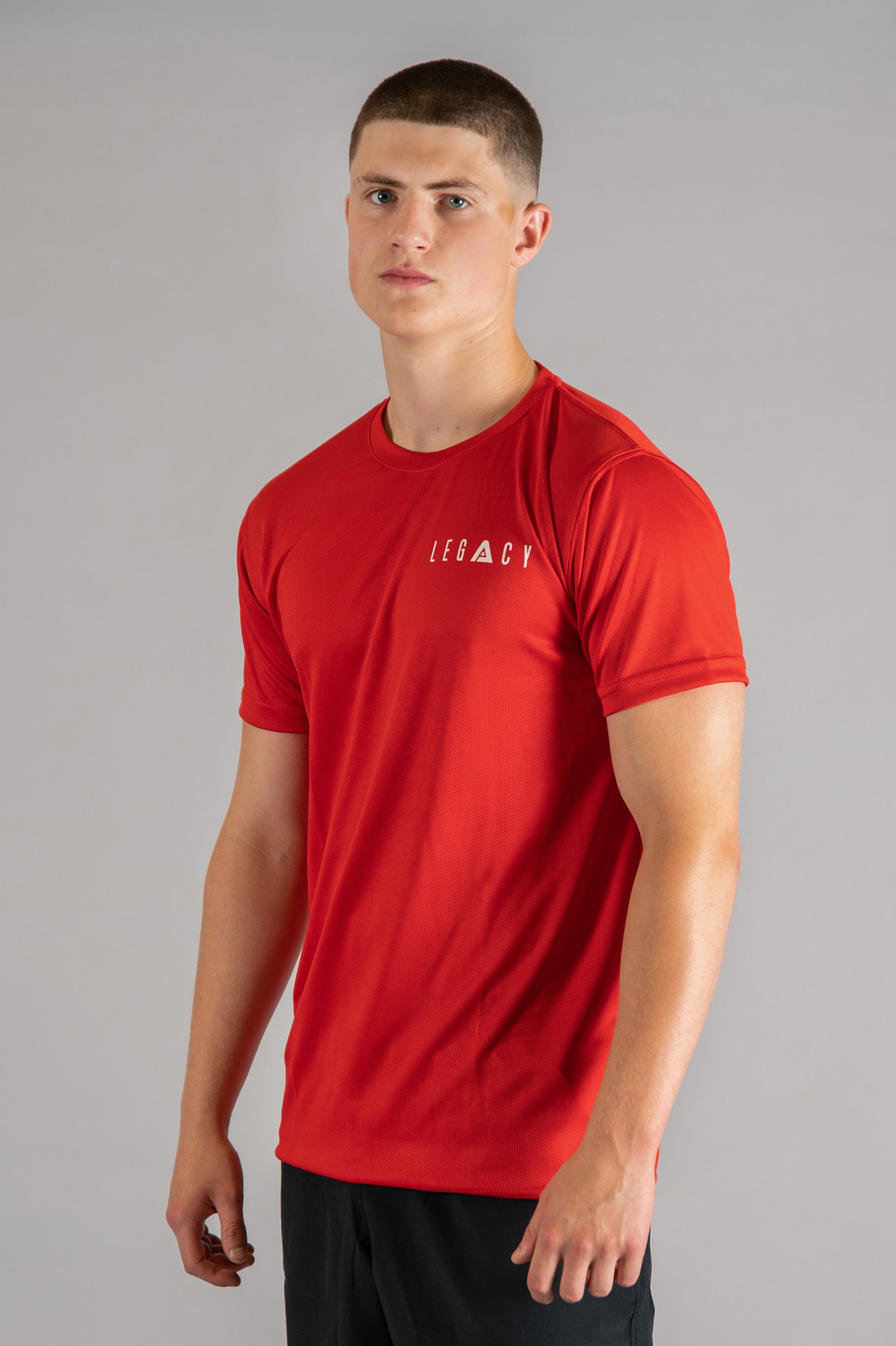 Men's red moisture wicking crewneck t-shirt with white logo.