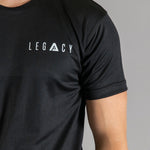 Close up of white logo on men's black moisture wicking crewneck t-shirt.