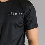 Close up of white logo on men's black moisture wicking crewneck t-shirt.