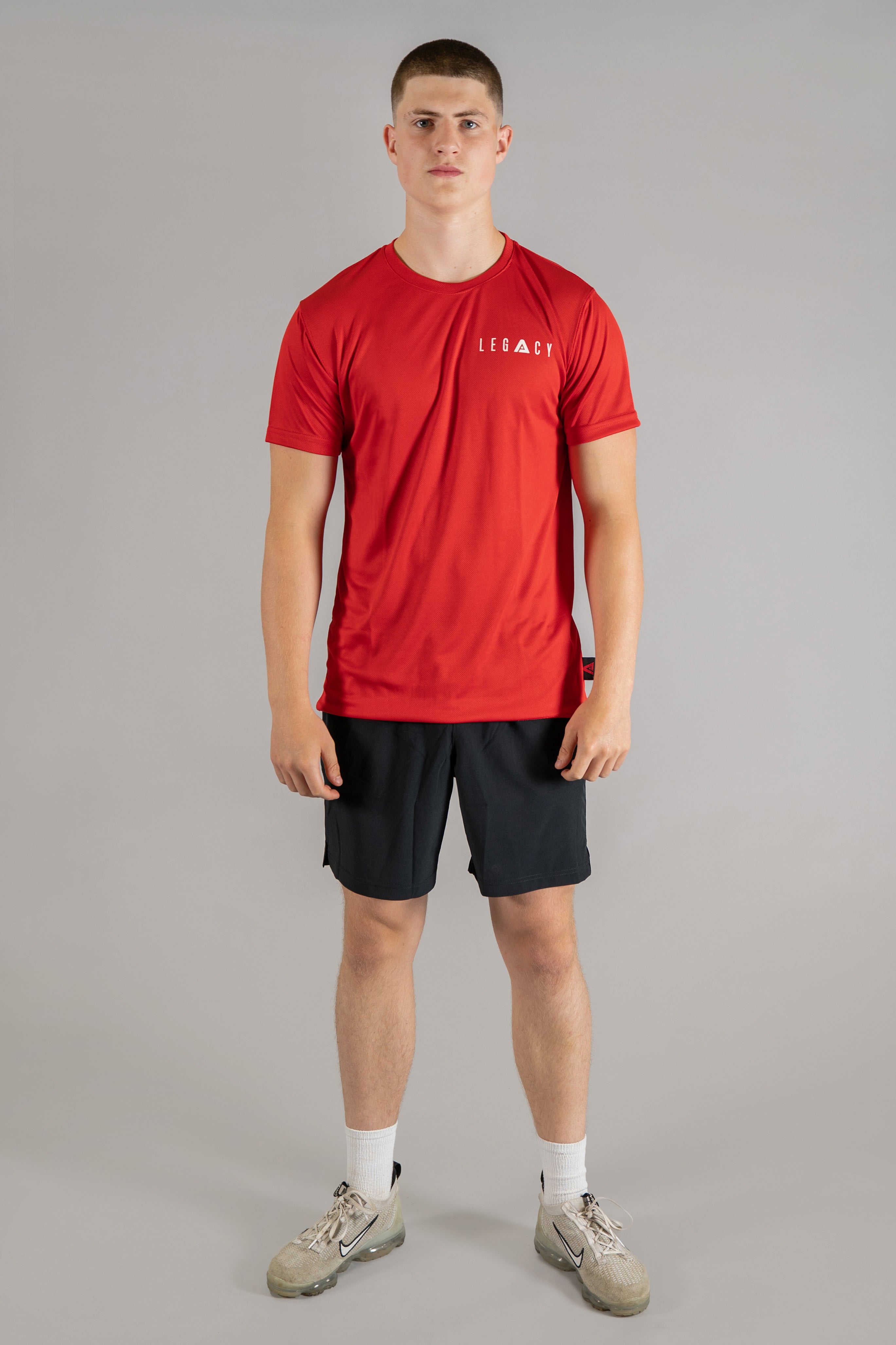 Men's red moisture wicking crewneck t-shirt with white logo.