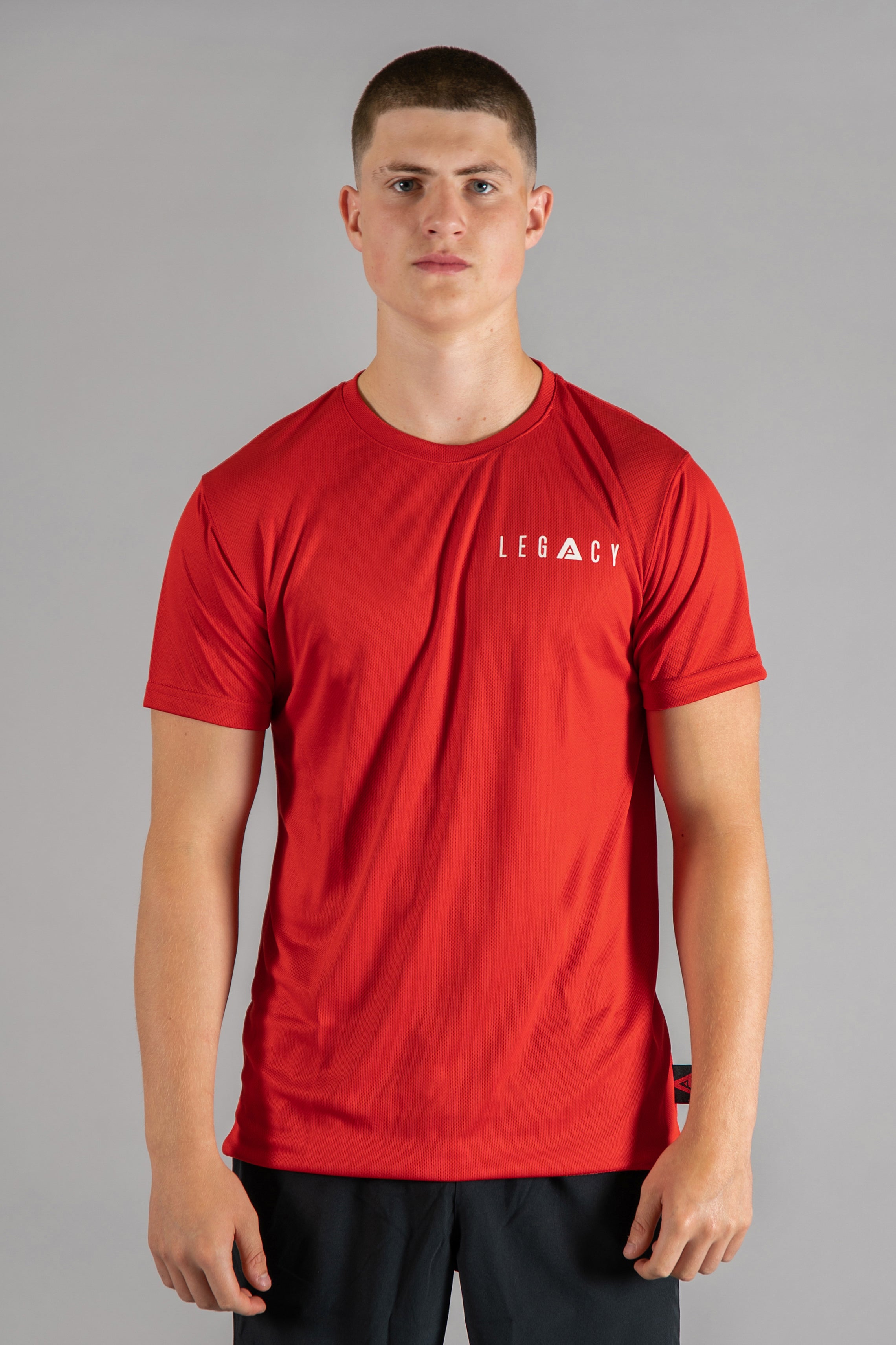 Men's red moisture wicking crewneck t-shirt with white logo.