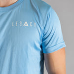 Close up of white logo on men's sky blue moisture wicking crewneck t-shirt.