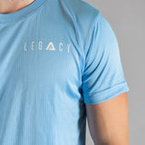 Close up of white logo on men's sky blue moisture wicking crewneck t-shirt.