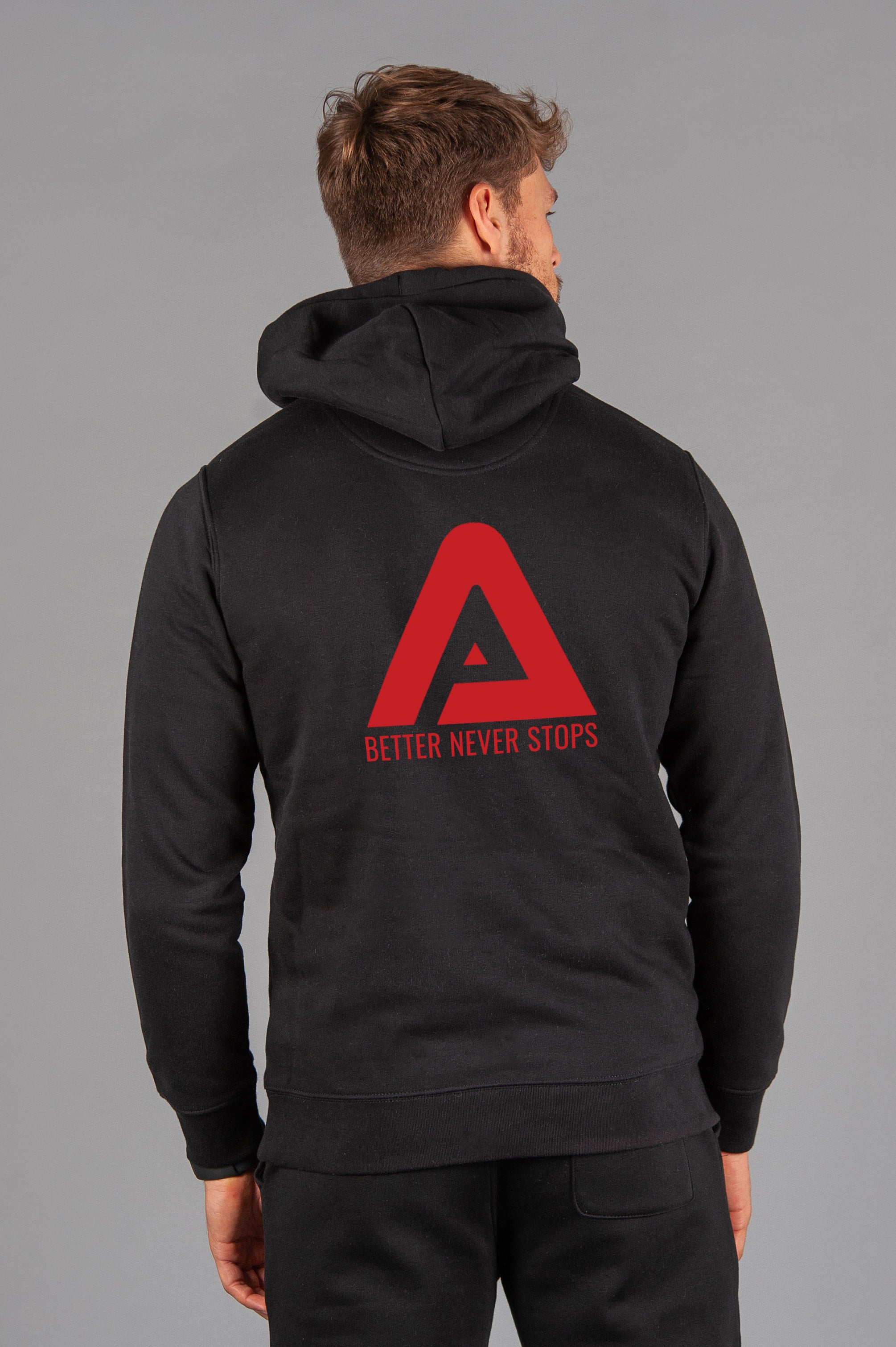 Back view of men's black hoodie with red Better Never Stops logo.