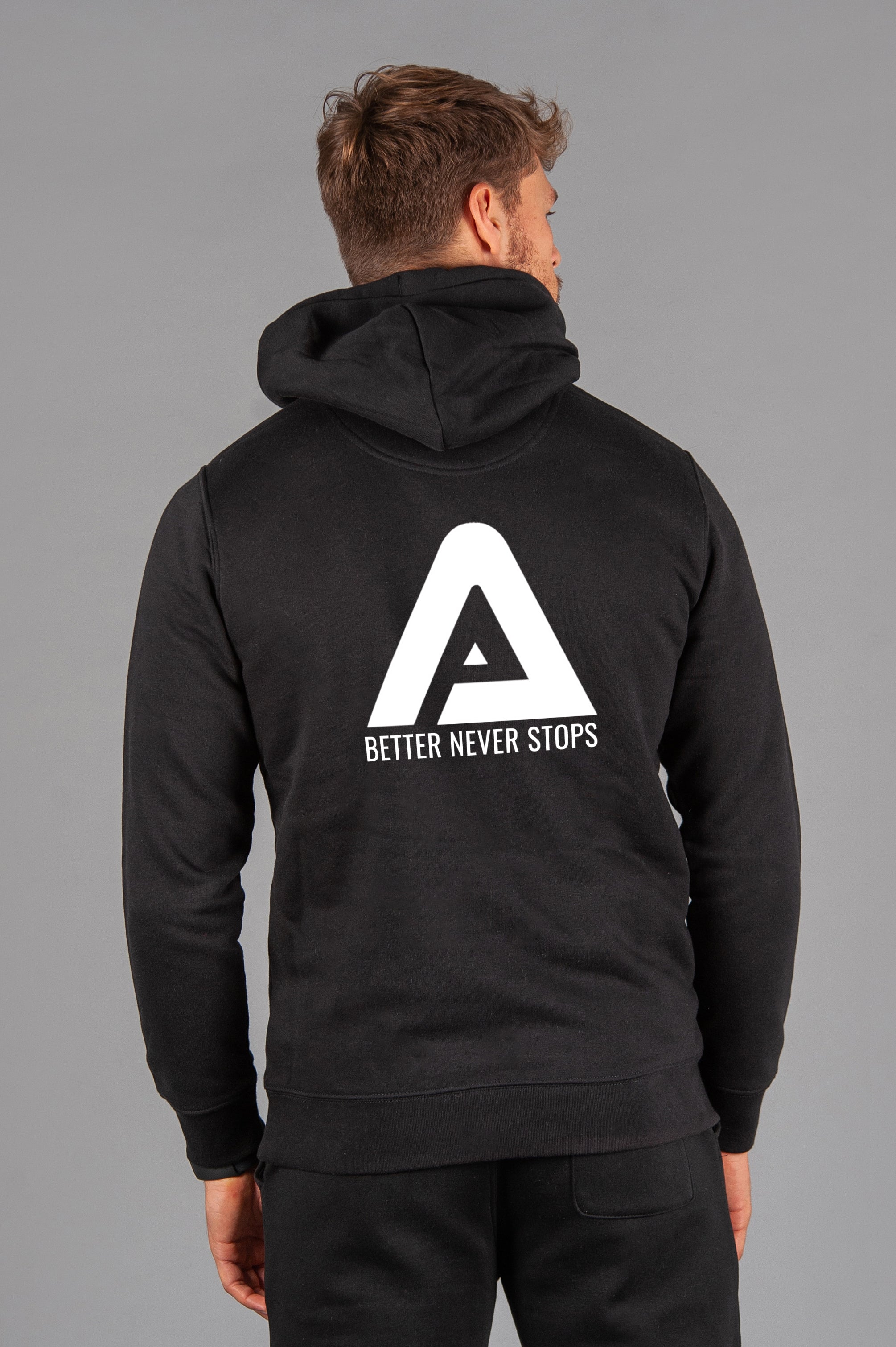 Back view of men's black hoodie with white Better Never Stops logo.