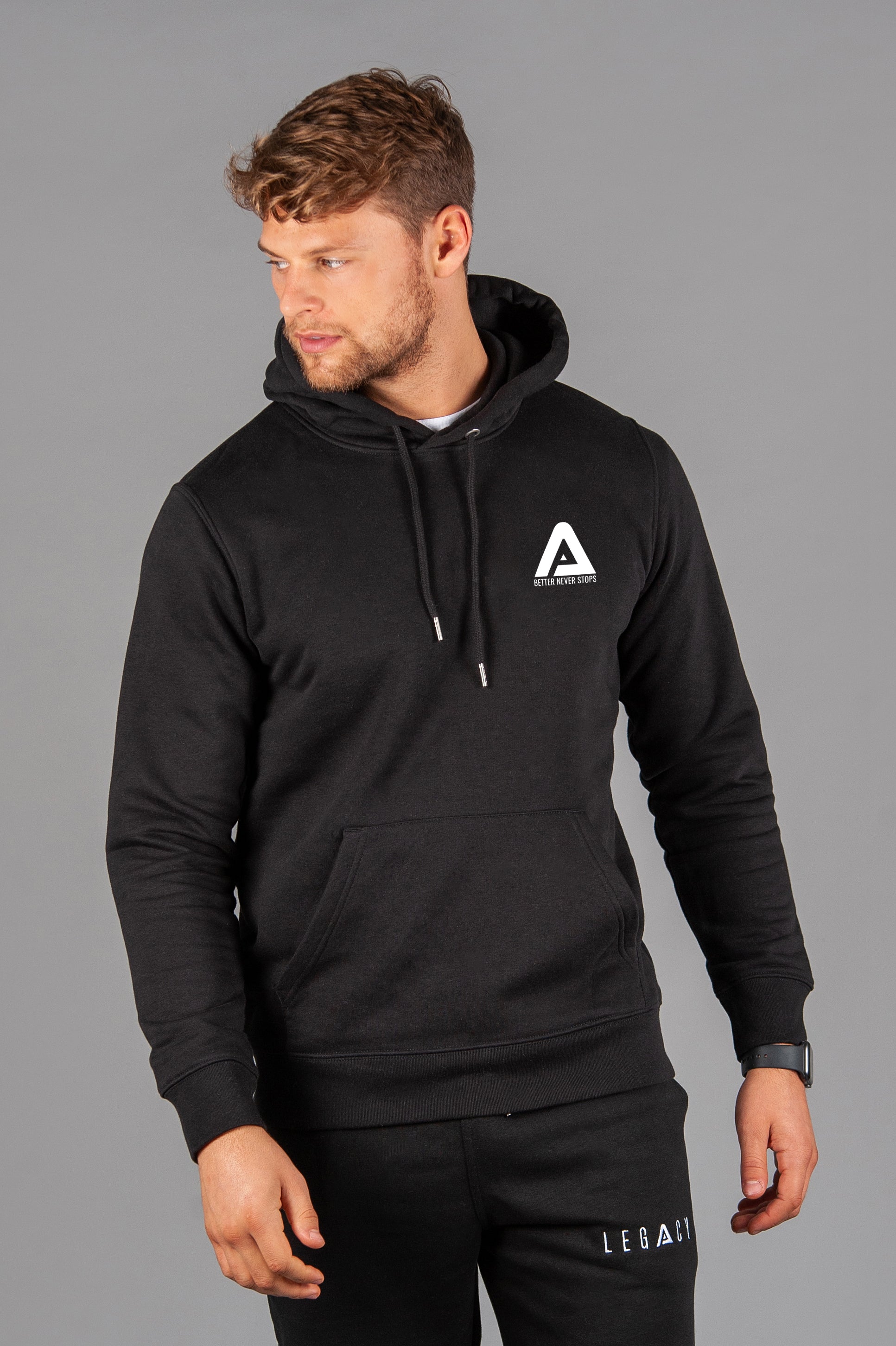 Men's black hoodie with small white Better Never Stops logo. 