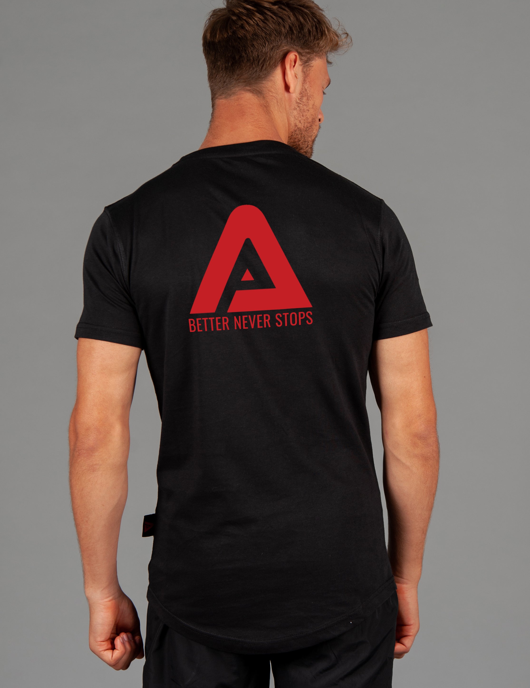 Back view of men's black t-shirt with red Better Never Stops logo. 