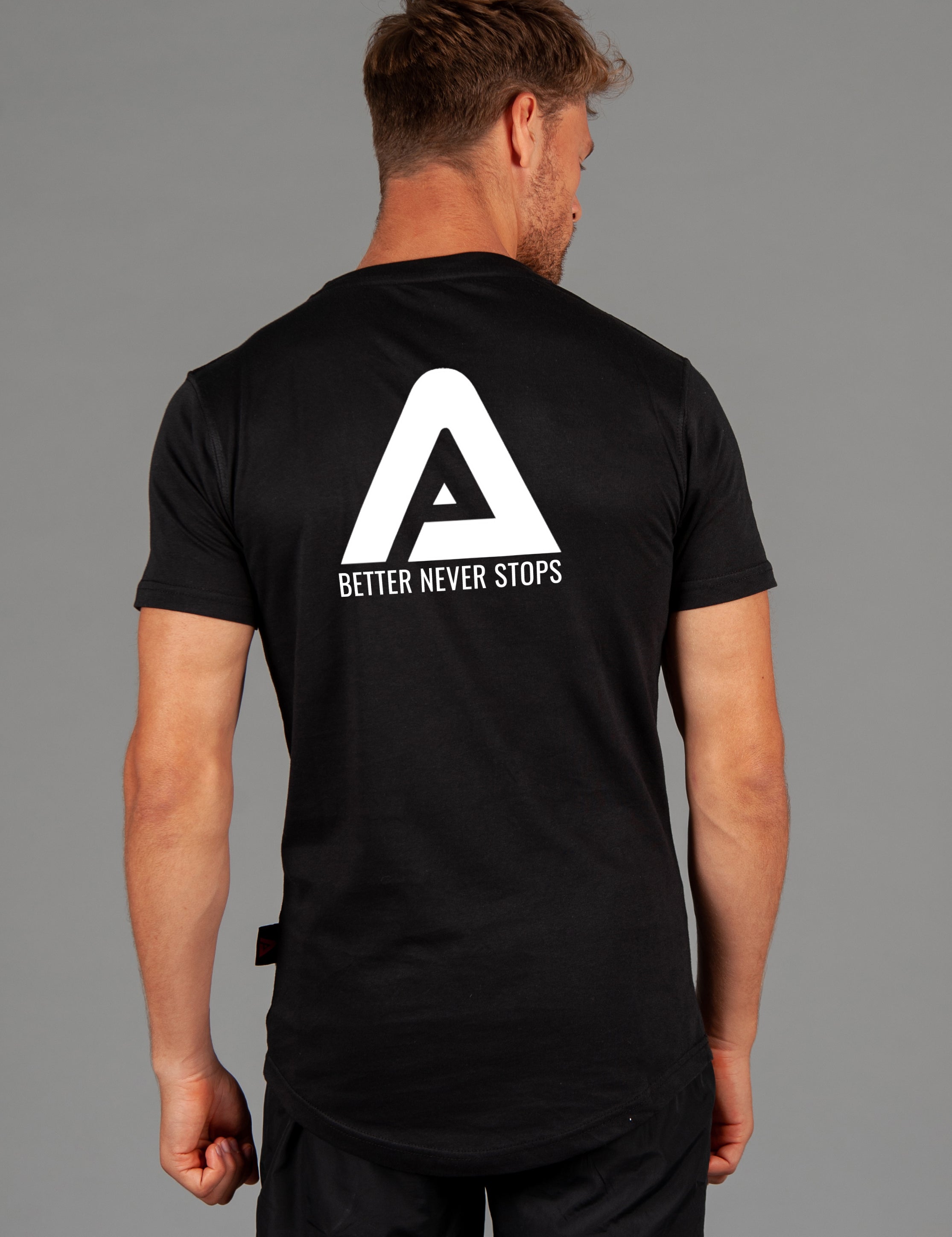 Back view of men's black t-shirt with white Better Never Stops logo.