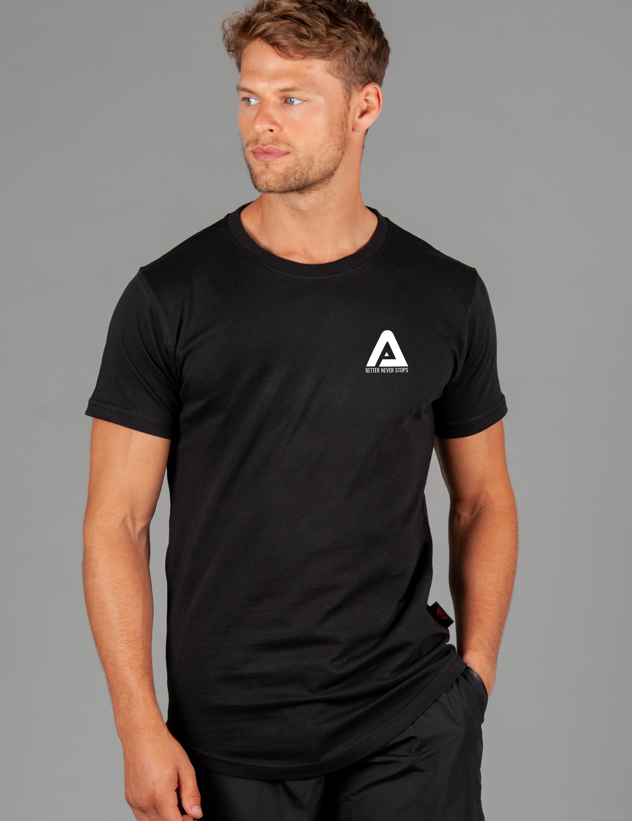 Men's black t-shirt with small white Better Never Stops logo. 