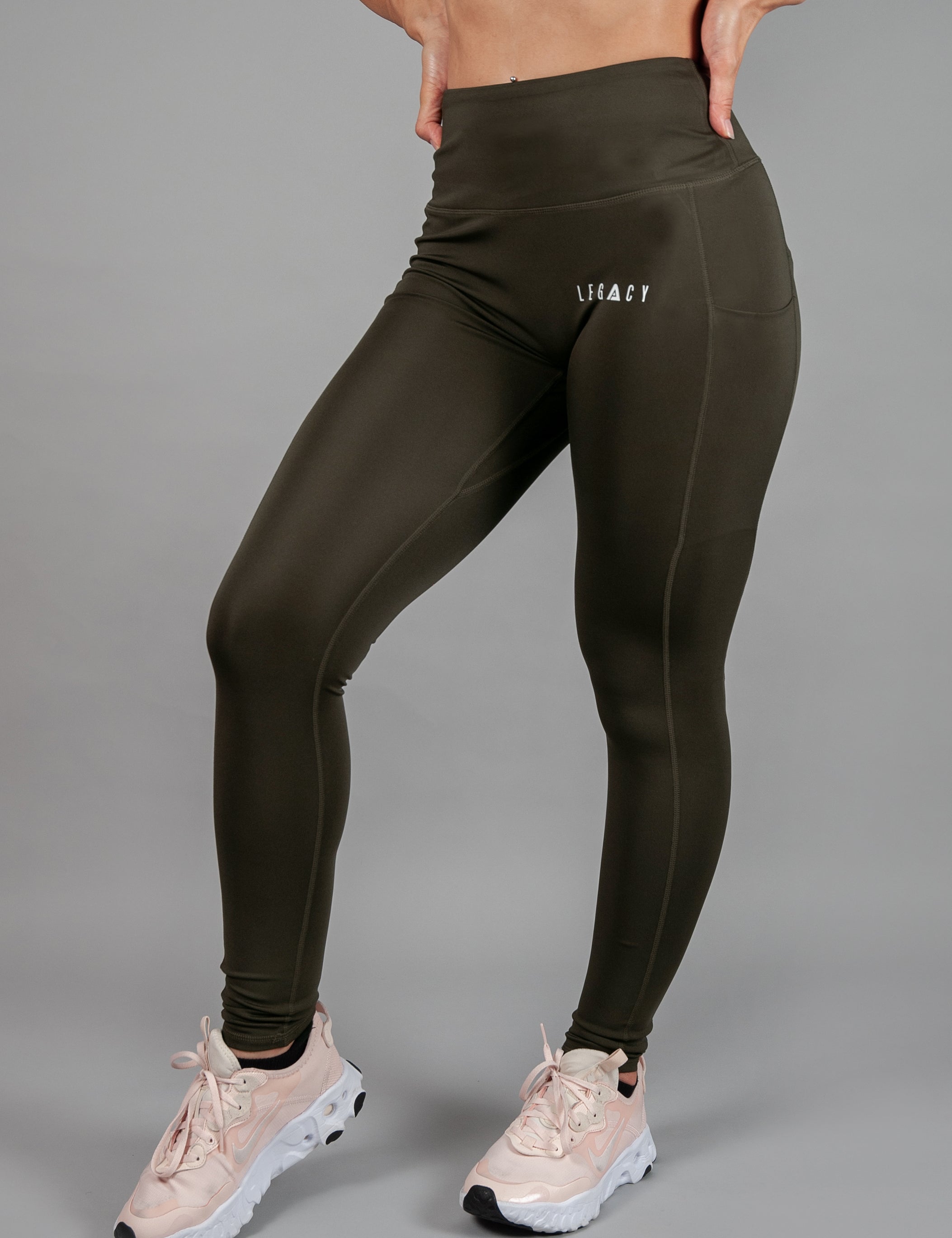 Women's olive full length workout leggings with small white hip logo.