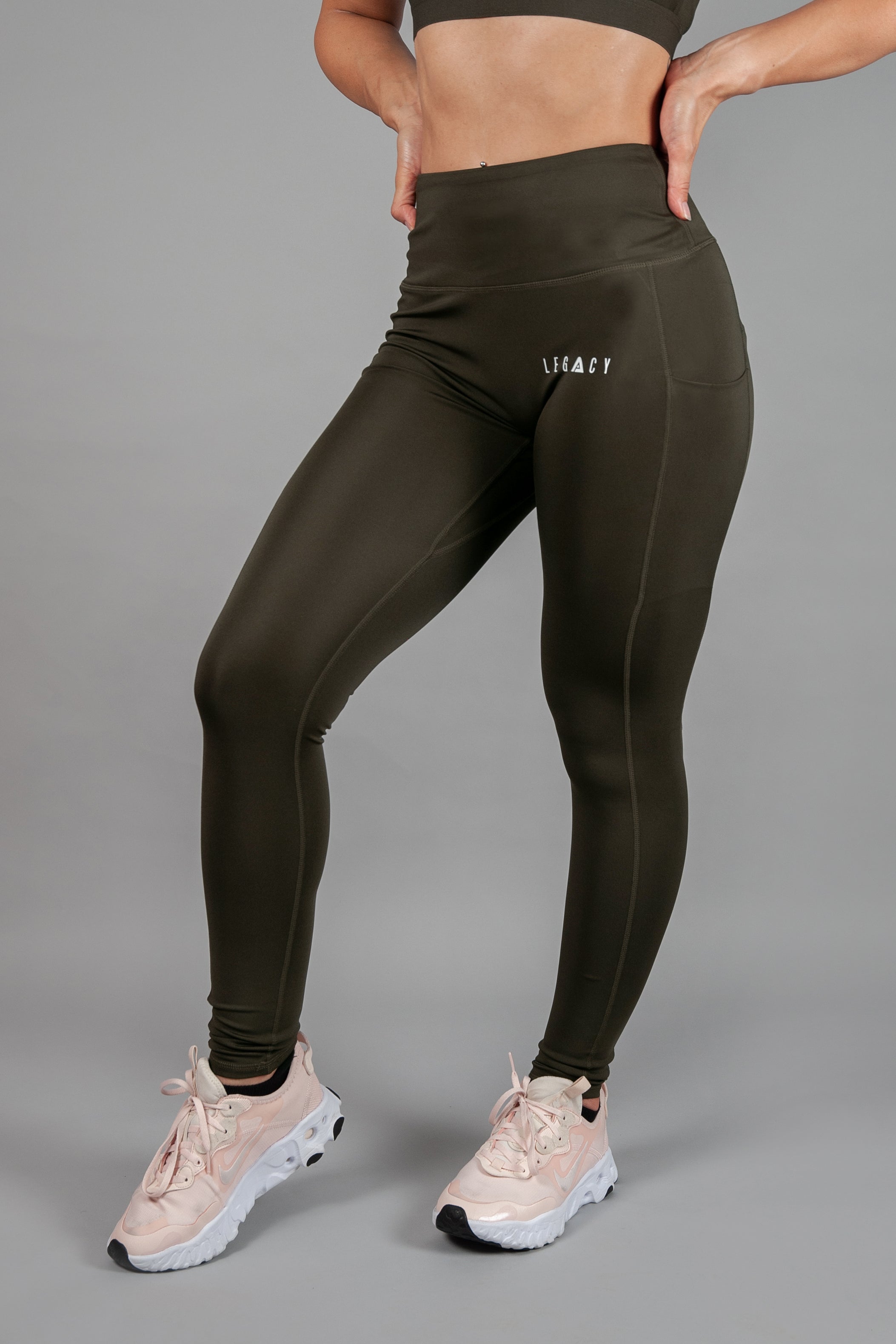 Women's olive full length workout leggings with small white hip logo.