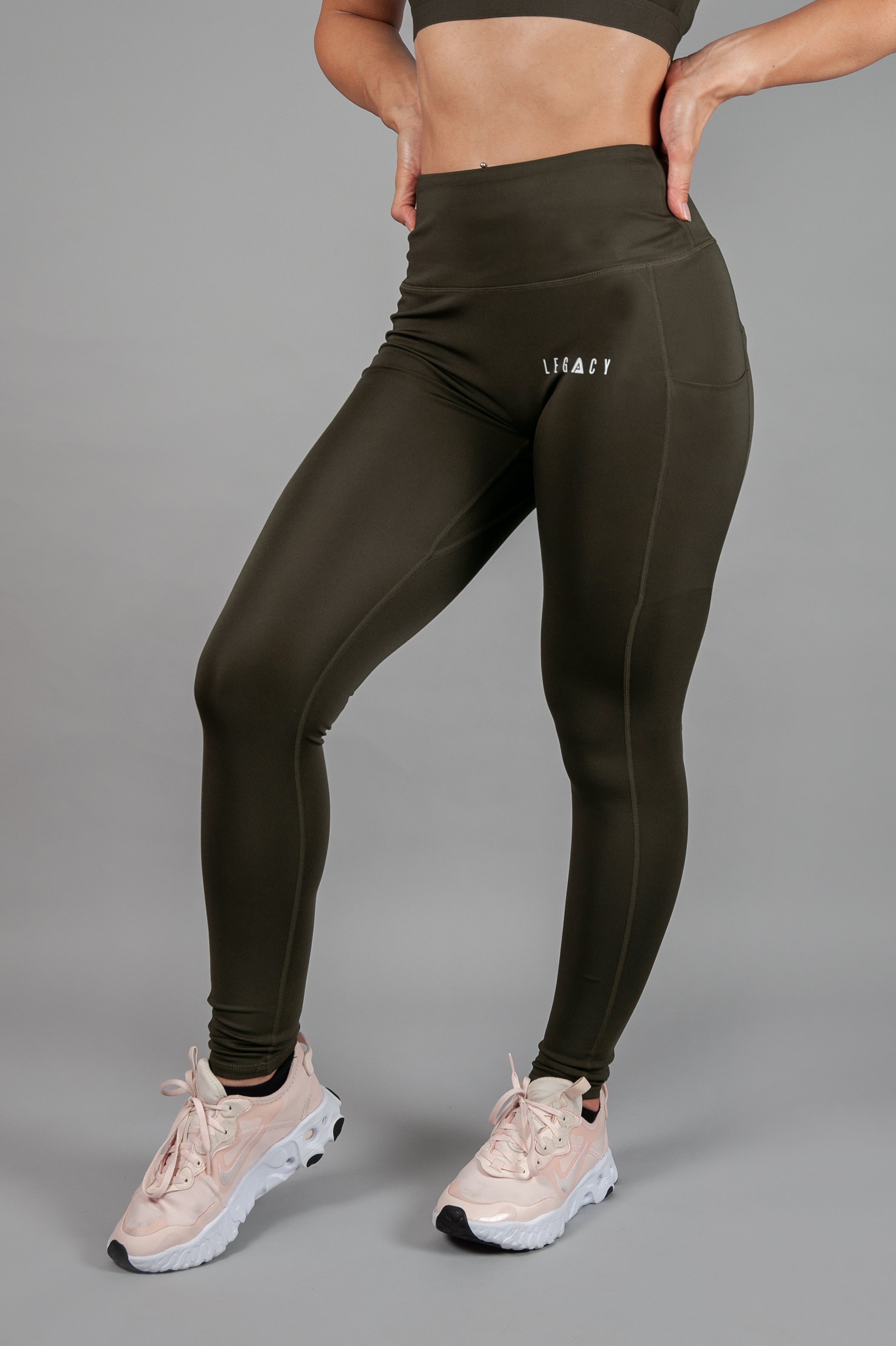 Women's olive full length workout leggings with small white hip logo.