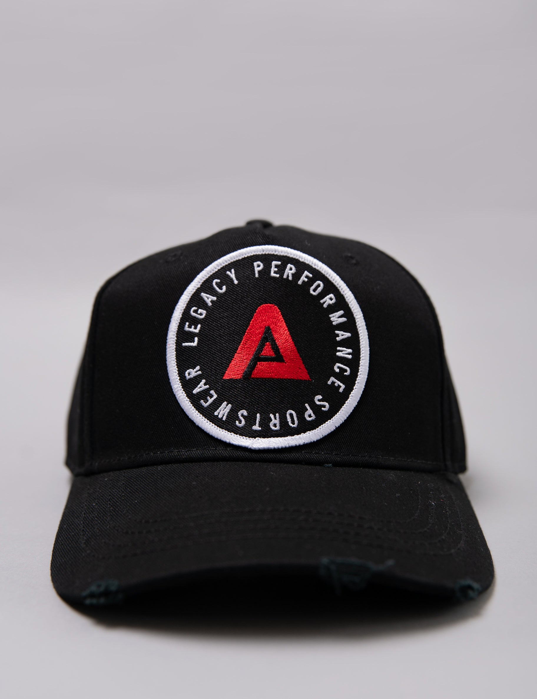 Black Legacy baseball cap with white and red logo.