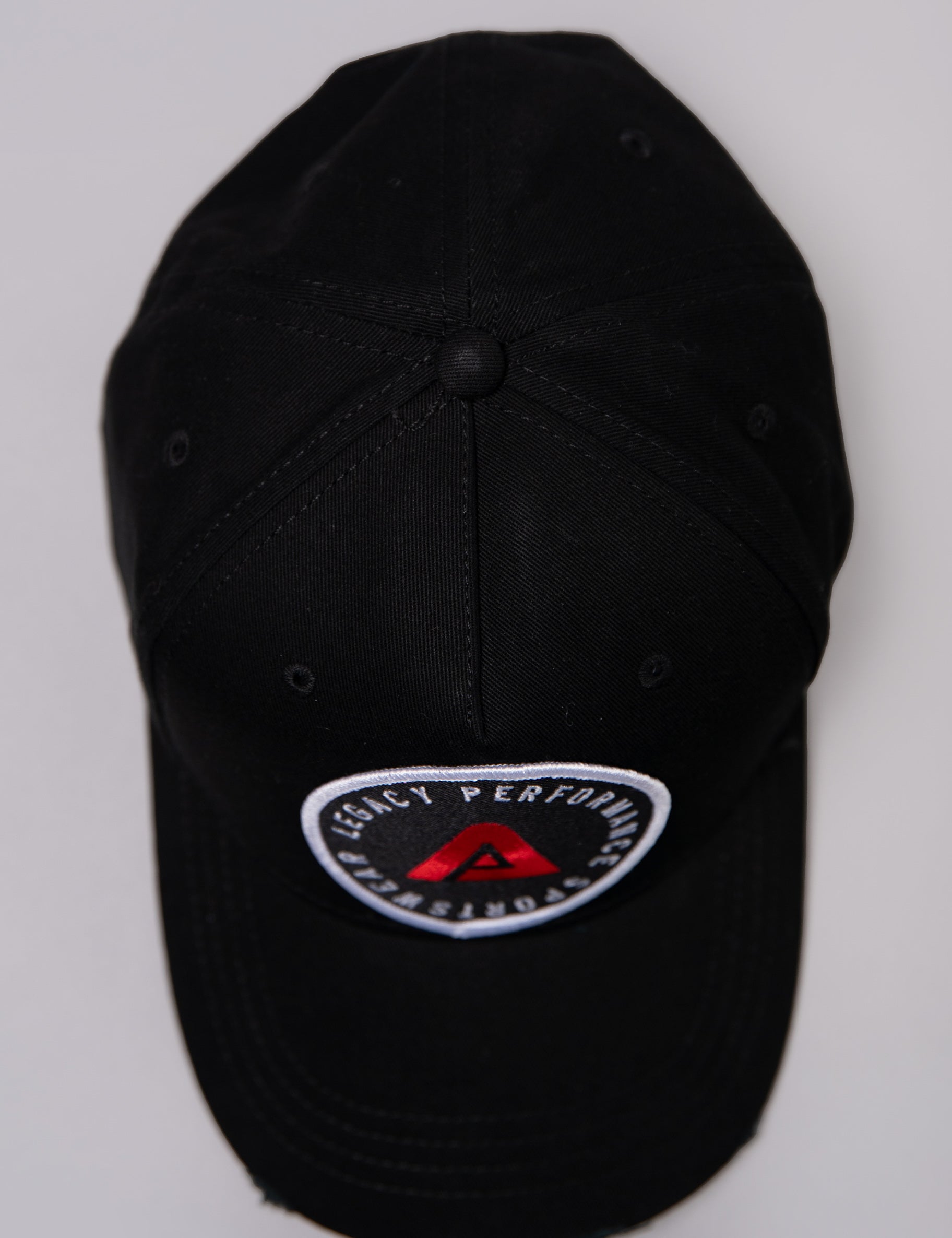 Black Legacy baseball cap with white and red logo. 