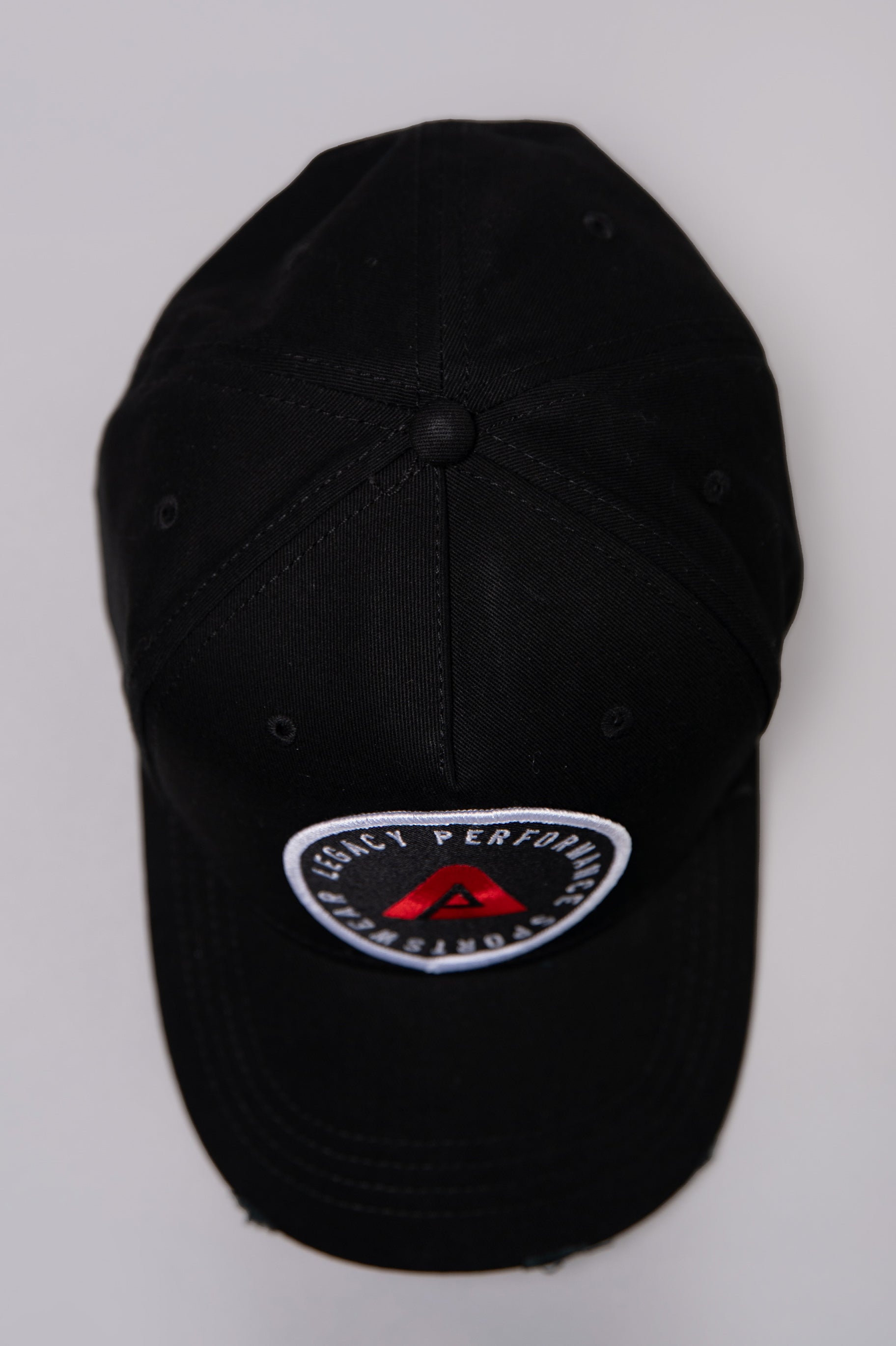 Black Legacy baseball cap with white and red logo. 