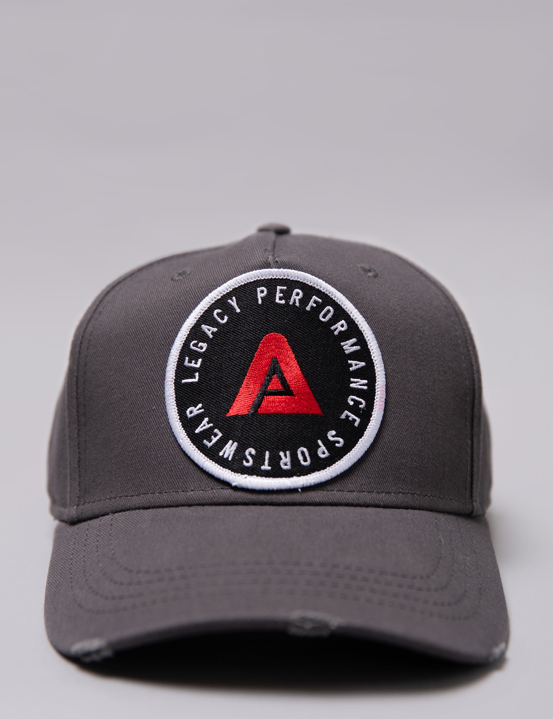 Grey Legacy baseball cap with white, red and black logo.