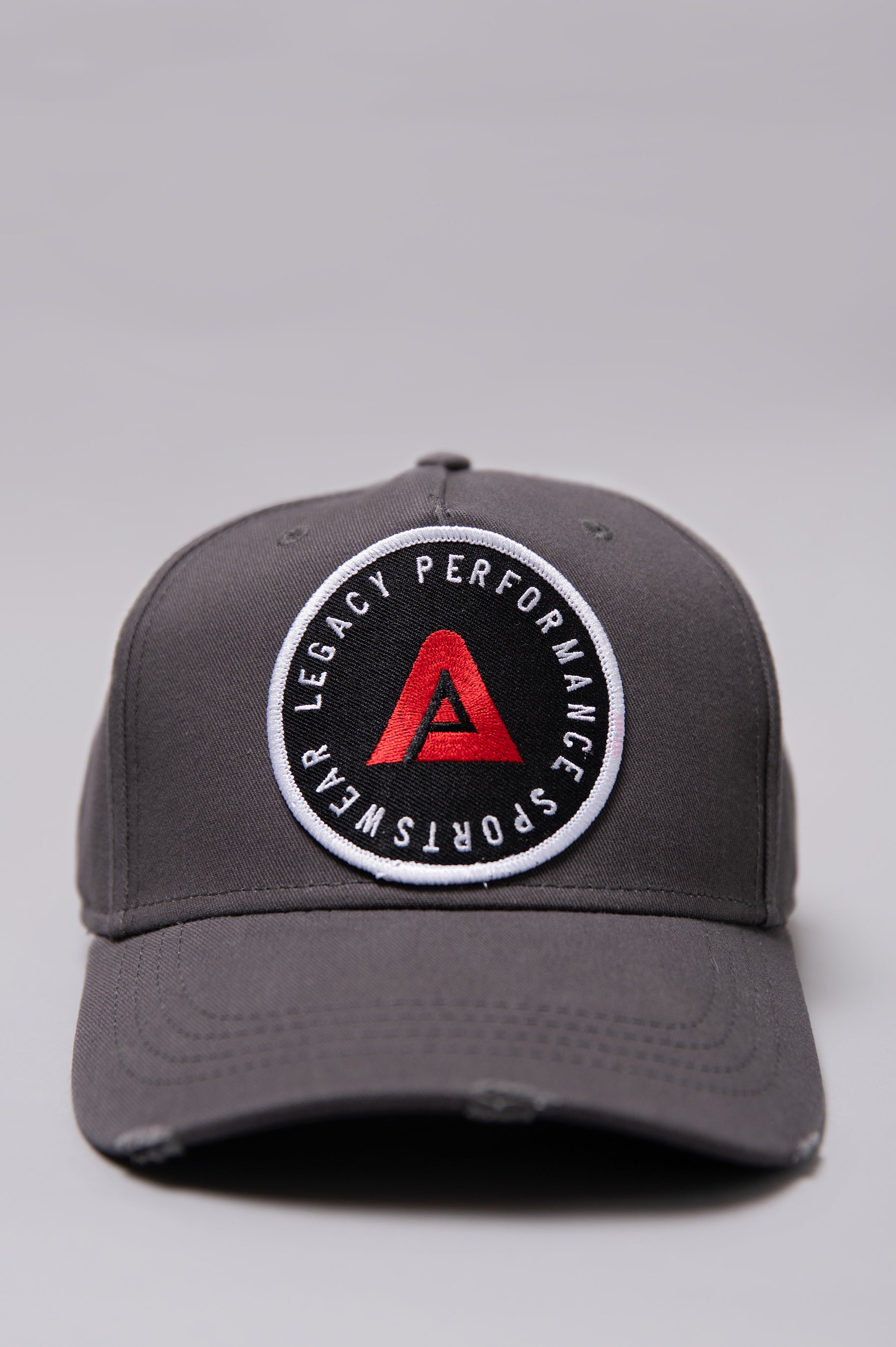 Grey Legacy baseball cap with white, red and black logo.