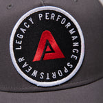 Grey Legacy baseball cap with white, red and black logo.