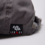 Close up of Lucky Seven x Legacy tag on grey baseball cap.