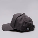 Side view of grey Legacy baseball cap with white, red and black logo.