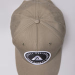 Khaki Legacy baseball cap with black and white logo.