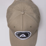 Khaki Legacy baseball cap with black and white logo.