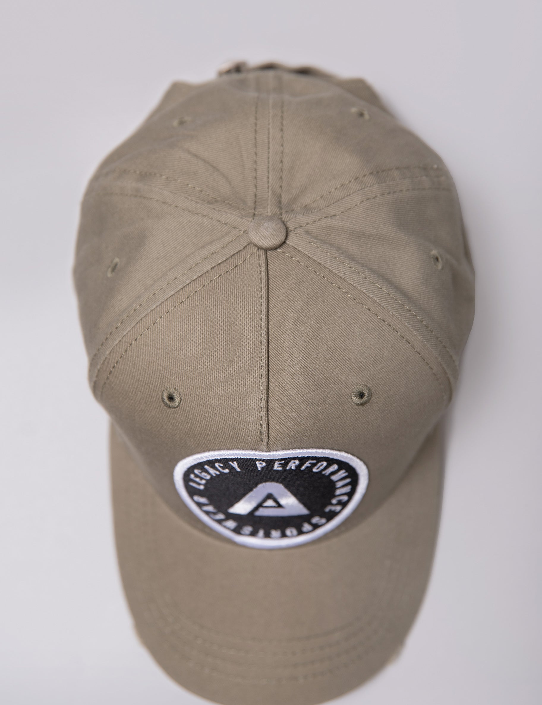 Khaki Legacy baseball cap with black and white logo.