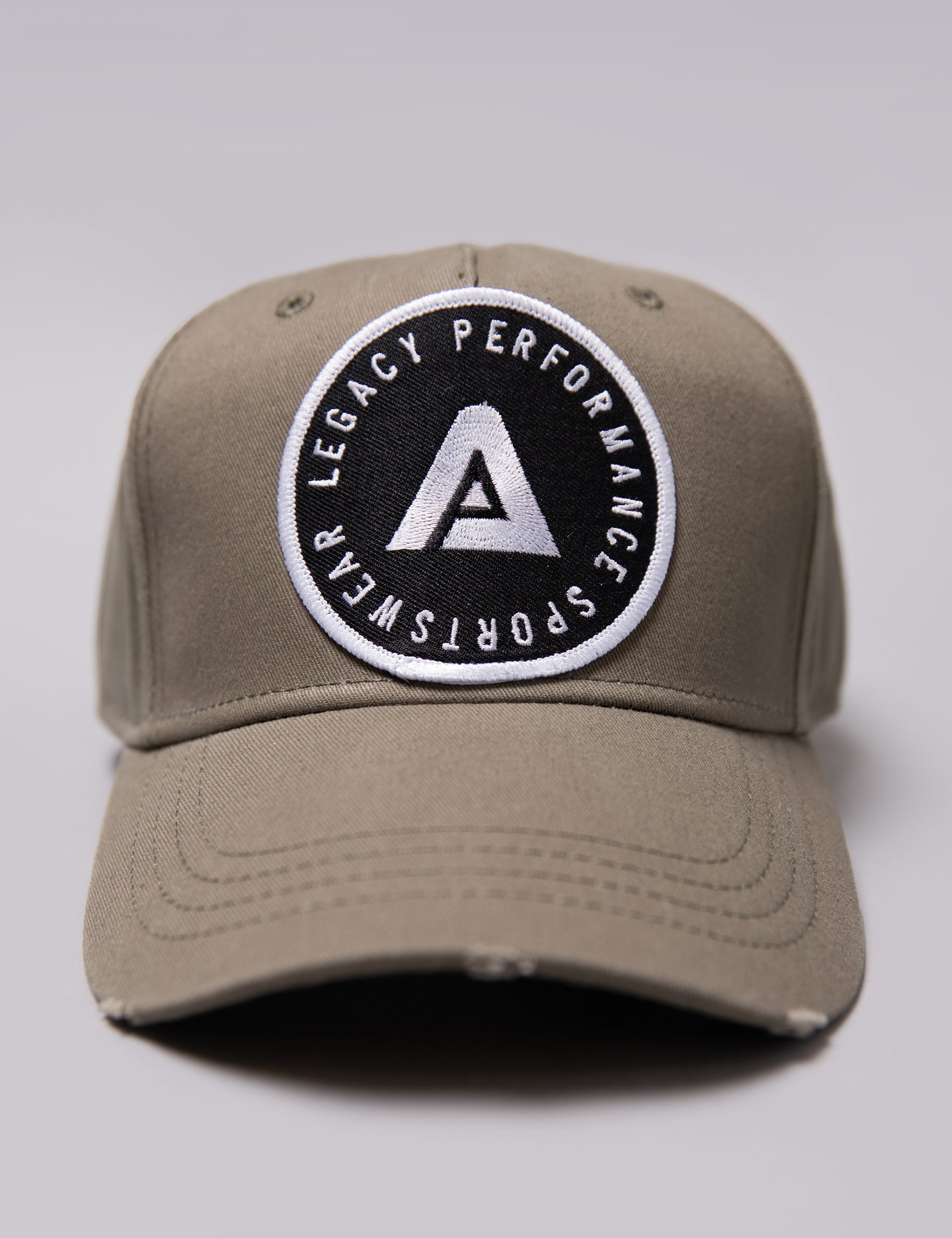 Khaki Legacy baseball cap with black and white logo.