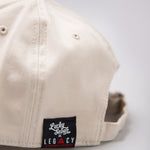 Close up of Legacy x Lucky Seven tag on stone baseball cap.