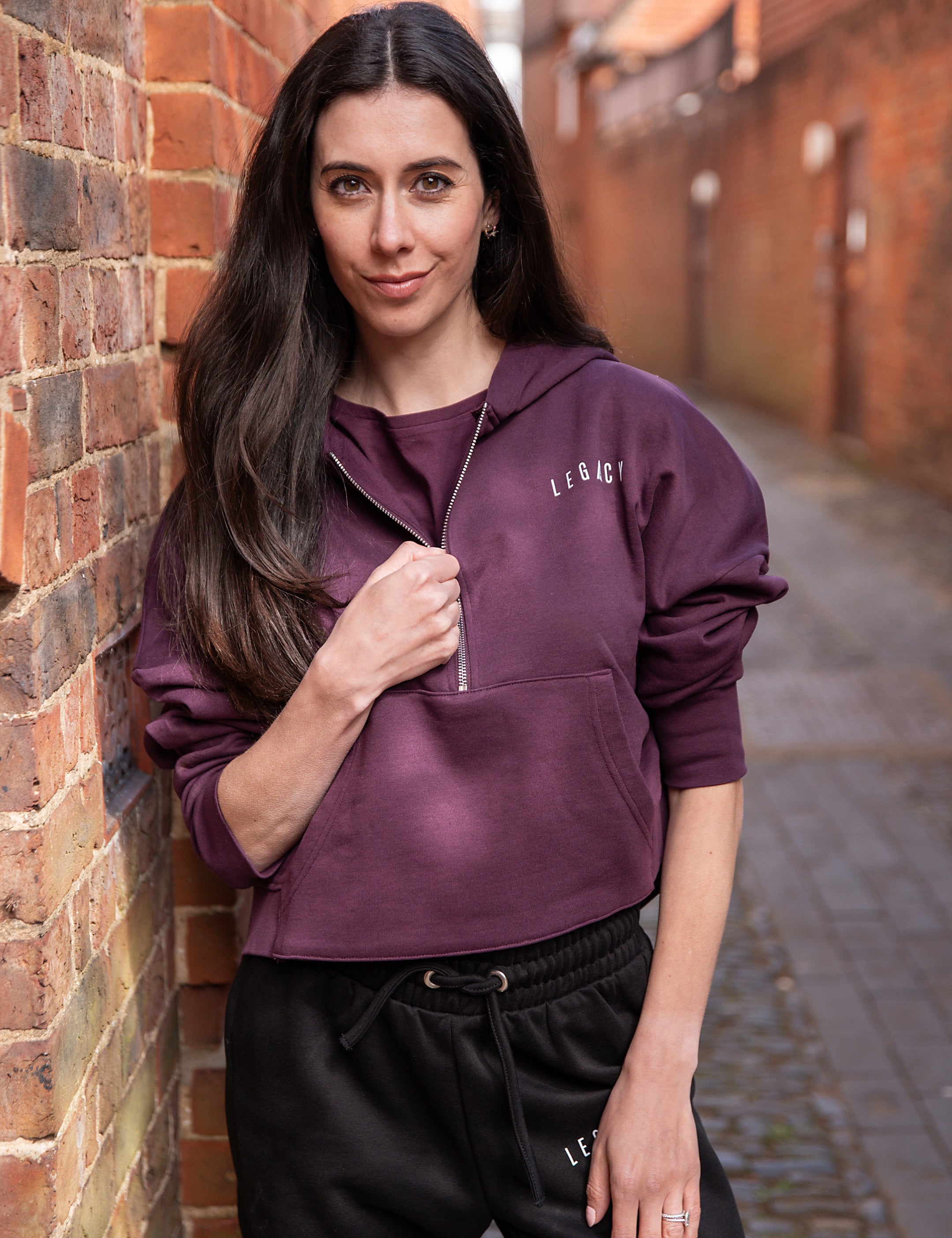 Women's burgundy 1/4 zip cropped hoodie with front pocket and small white logo.