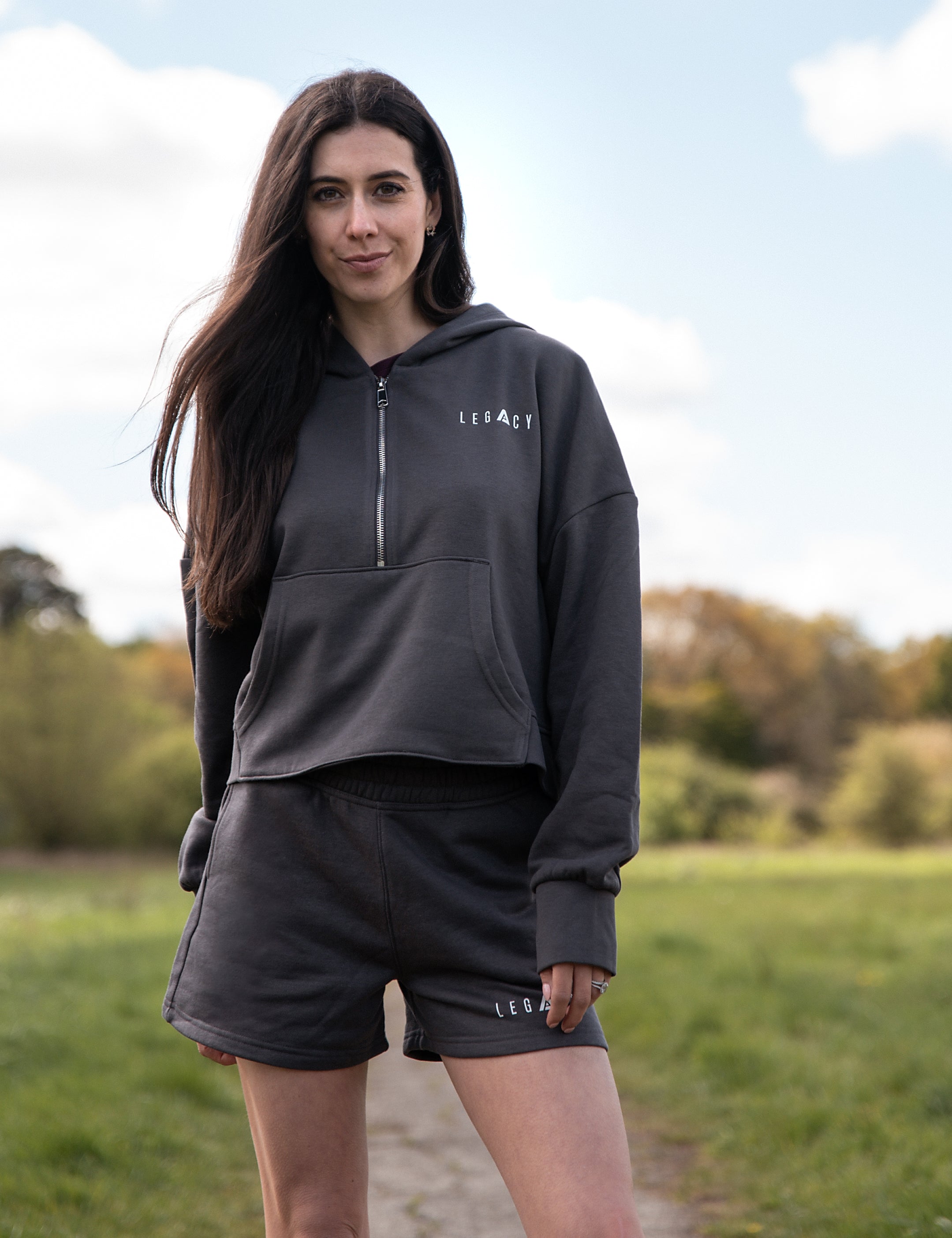 Women's graphite 1/4 zip cropped hoodie with small white logo.