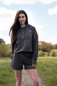 Women's graphite 1/4 zip cropped hoodie with small white logo.