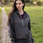 Women's graphite 1/4 zip cropped hoodie with small white logo.