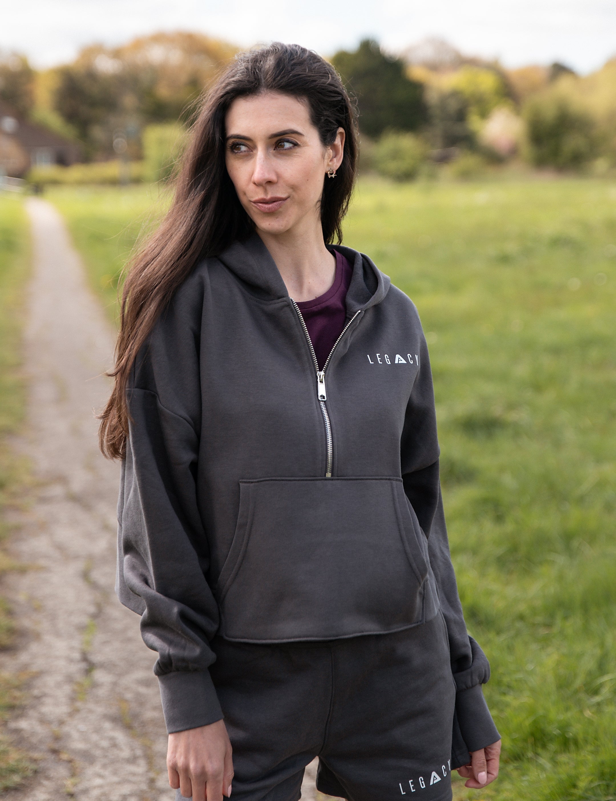Women's graphite 1/4 zip cropped hoodie with small white logo.