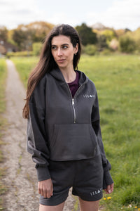 Women's graphite 1/4 zip cropped hoodie with small white logo.