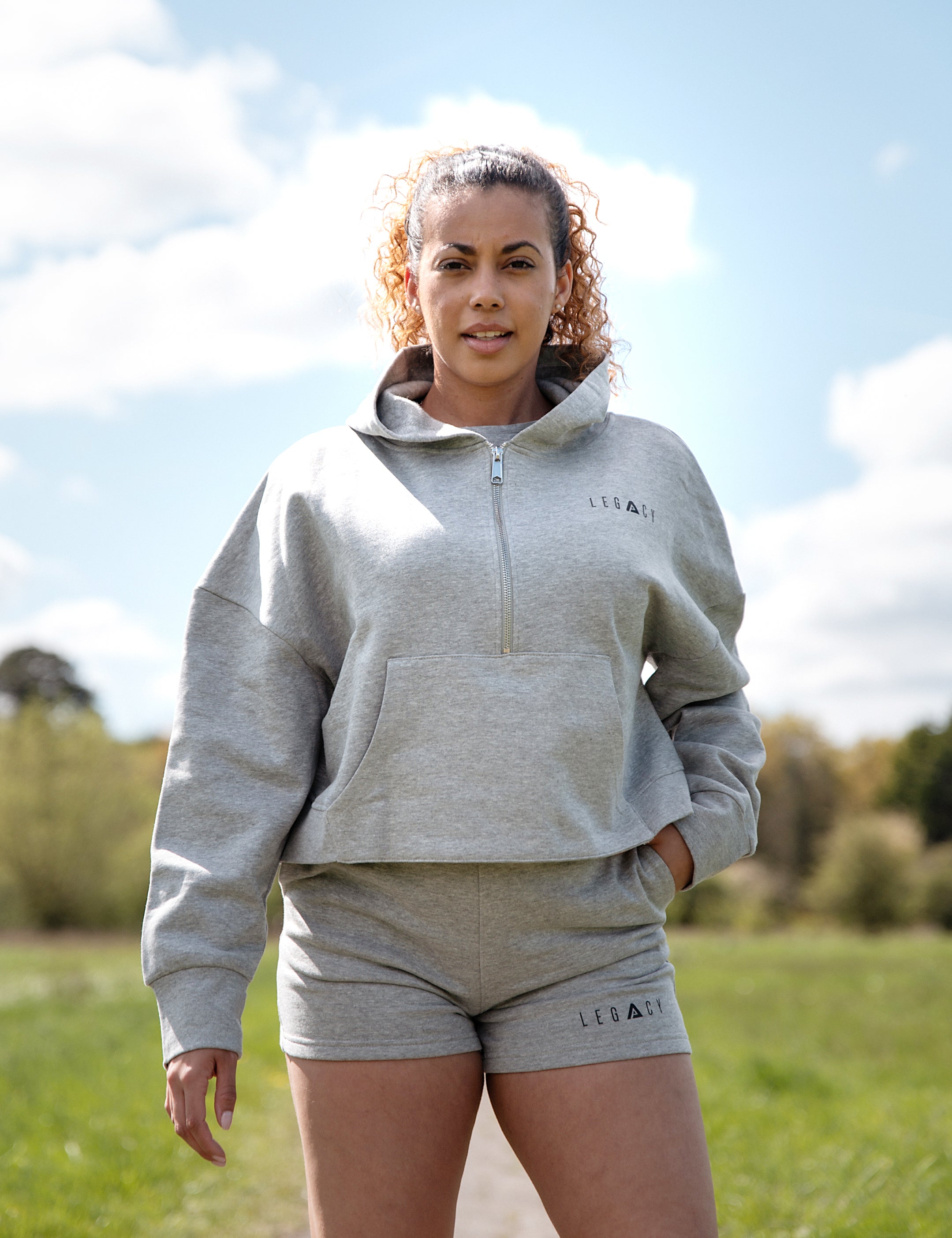 Women's grey 1/4 zip cropped hoodie with small black logo.