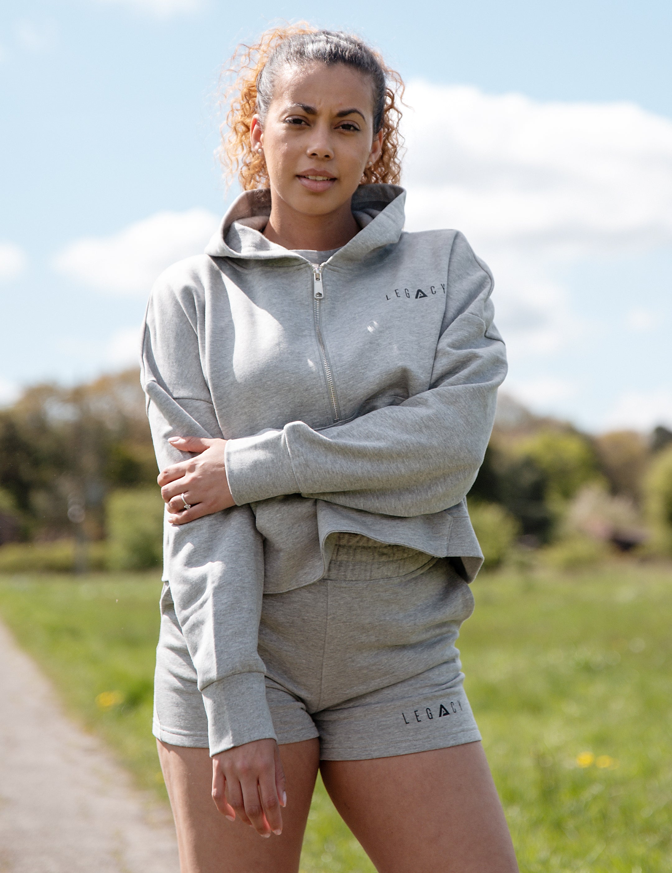 Women's grey 1/4 zip cropped hoodie with small black logo.