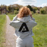 Back view of women's grey oversized crop hoodie with tie waist and black Better Never Stops logo.