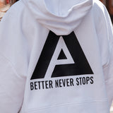 Back view of women's white oversized crop hoodie with tie waist and black Better Never Stops logo.