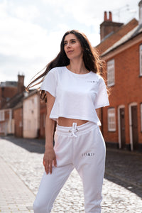 Women's white crop t-shirt with small black logo.