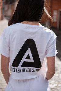 Back view of women's white crop t-shirt with black Better Never Stops logo.